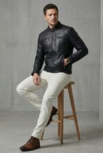 Black Moto Leather Jacket Sitting Pose - Vanguard