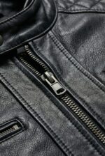 Gunmetal YKK zipper detail on men’s black moto leather jacket