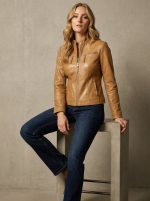 Women's tan leather cafe racer jacket shown on model with a tailored slim fit